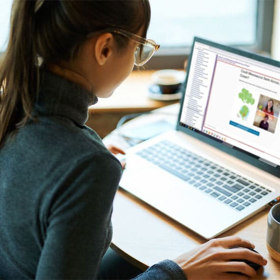 A teenage girl viewing a sample lesson on a laptop computer