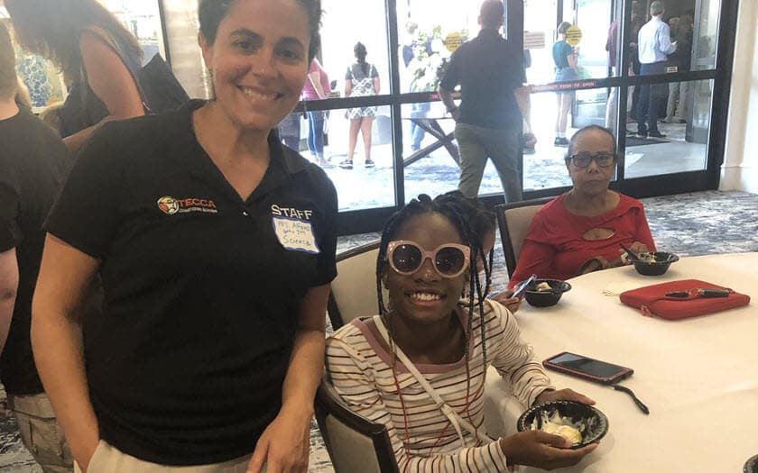 A TECCA student and teacher socializing at a Welcome Back to School Event