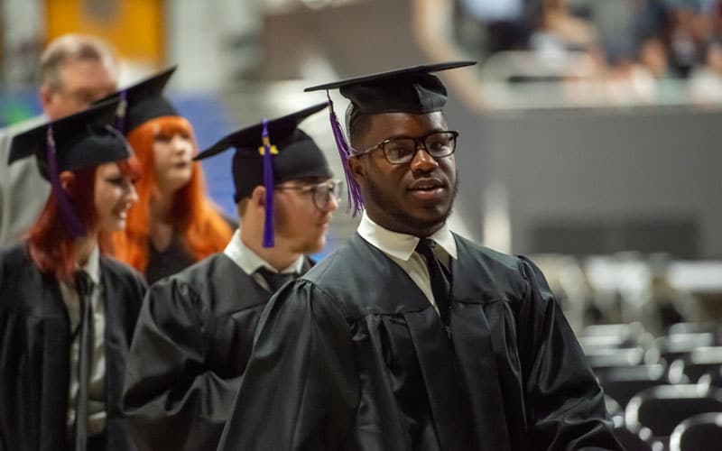 Alabama Connections Academy graduation, a student walks at commencement. 
