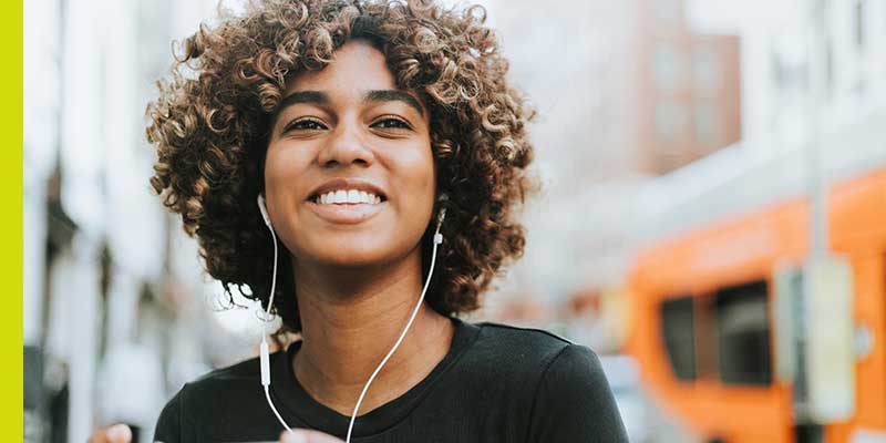 Online school student outside wearing headphones