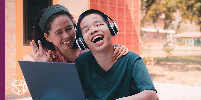 A young student with special needs learning online with his Learning Coach